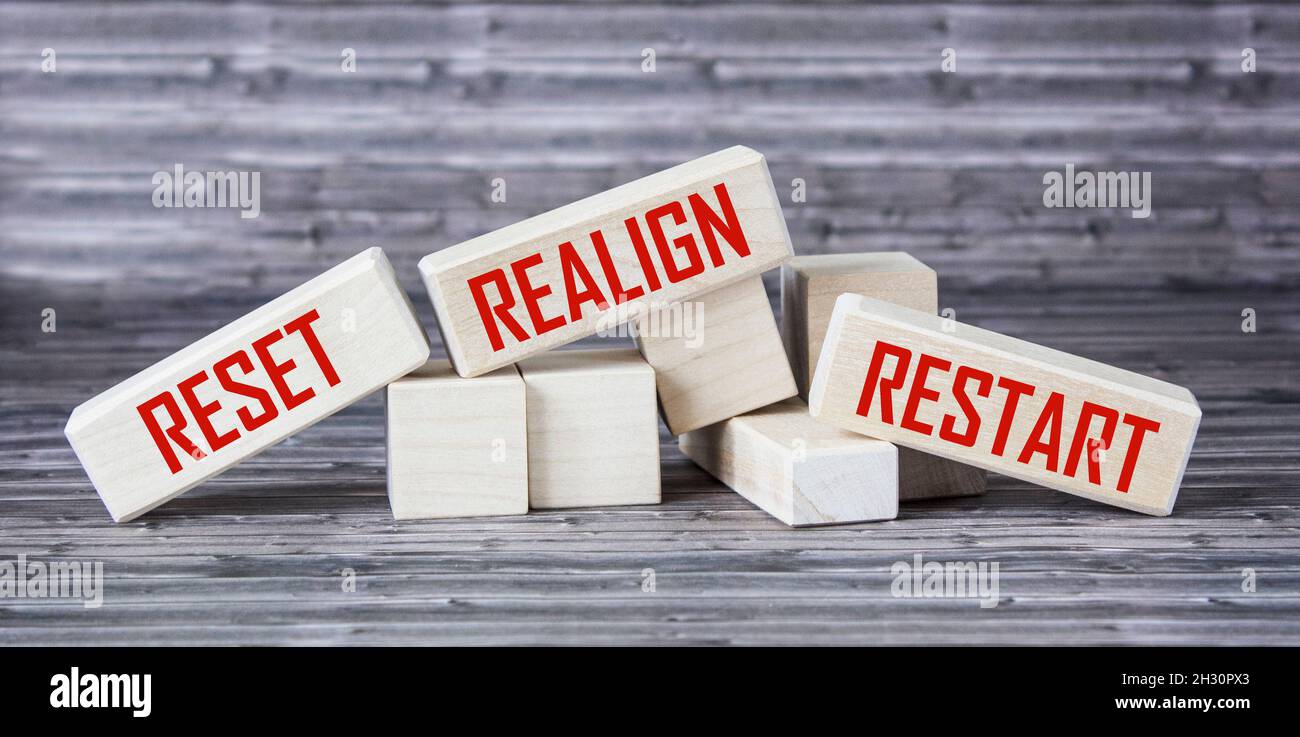 reset, realign, restart concept - abstract words written on wooden blocks Stock Photo