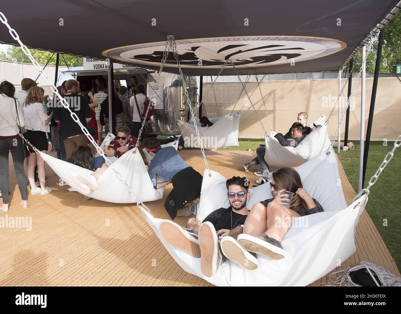 Festival goers relax in vodka bar hammocks on Day 1 of Field Day