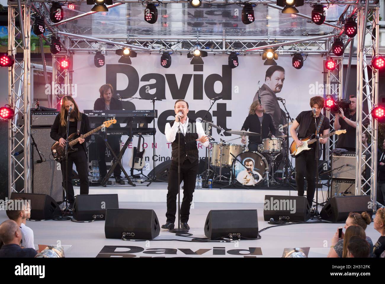 Ricky Gervais performs with Forgone Conclusion during the world