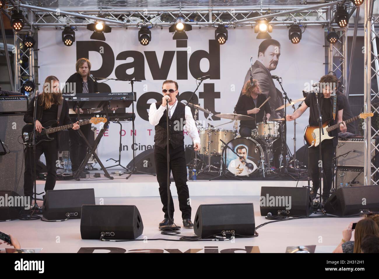 Ricky Gervais performs with Forgone Conclusion during the world