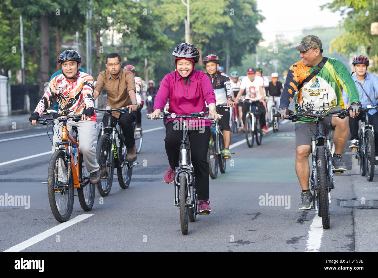 Tri Rismaharini, known as Bu Risma, takes part in a charity bike ride ...