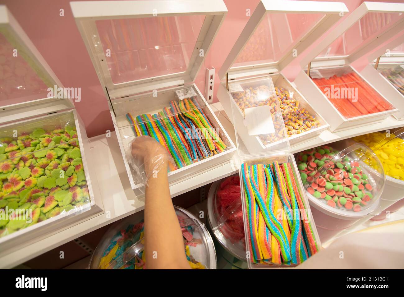 Jelly candies in containers in a store. Large selection of sweets in