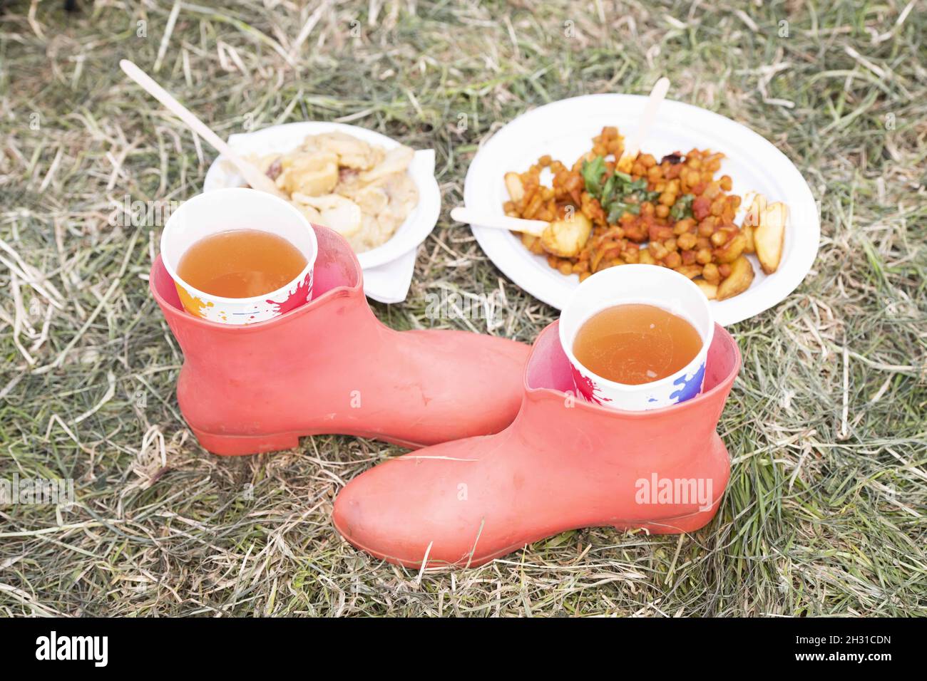Boots are used as a drinks holder on day 3 of Glastonbury 2019, Worthy Farm, Pilton, Somerset. Picture date: Friday 28th June 2019.  Photo credit should read:  David Jensen/EmpicsEntertainment Stock Photo