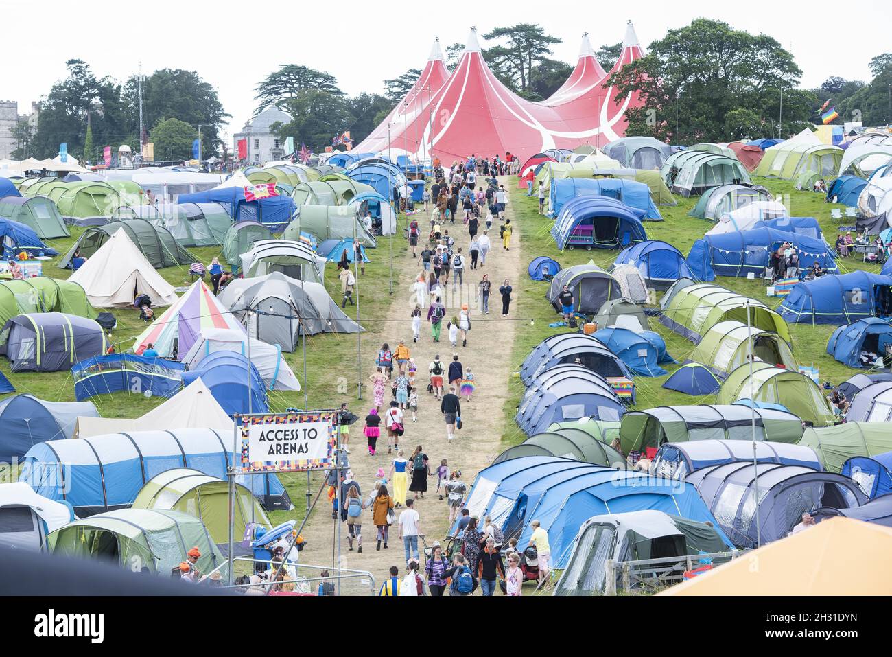 Festival Goers Climb A Hill Through The Main Campsite At Camp Bestival festival-goers-climb-a-hill-through-the-main-campsite-at-camp-bestival