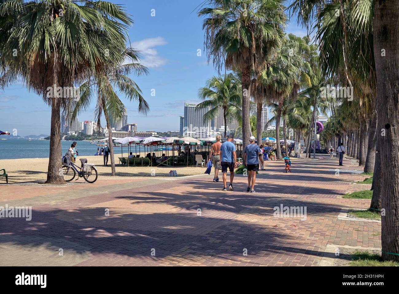 Pattaya Beach Thailand Southeast Asia with people strolling along in the warmth of the summer sun. Stock Photo