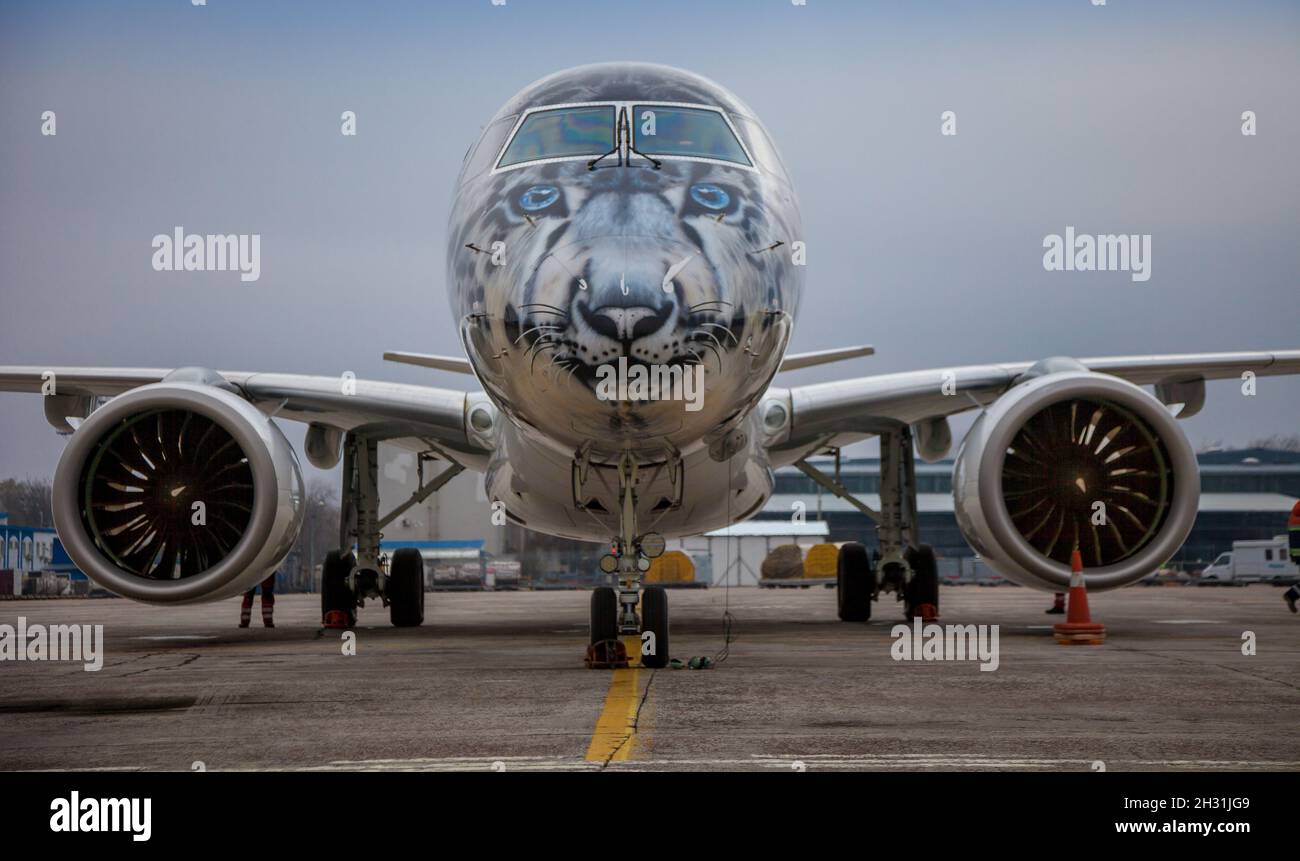 Kyiv, Ukraine - November 14, 2019: Airplane Embraer-190-E2 in the snow leopard livery. Airbrushing on the cockpit, livery - coloring by plane P4-KHA. Air Astana Kazakhstan. Fly in the Airport Stock Photo