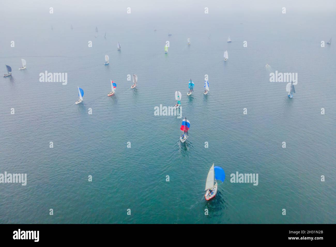 Aerial bird's eye view photo taken by drone of sailboat in turquoise ...