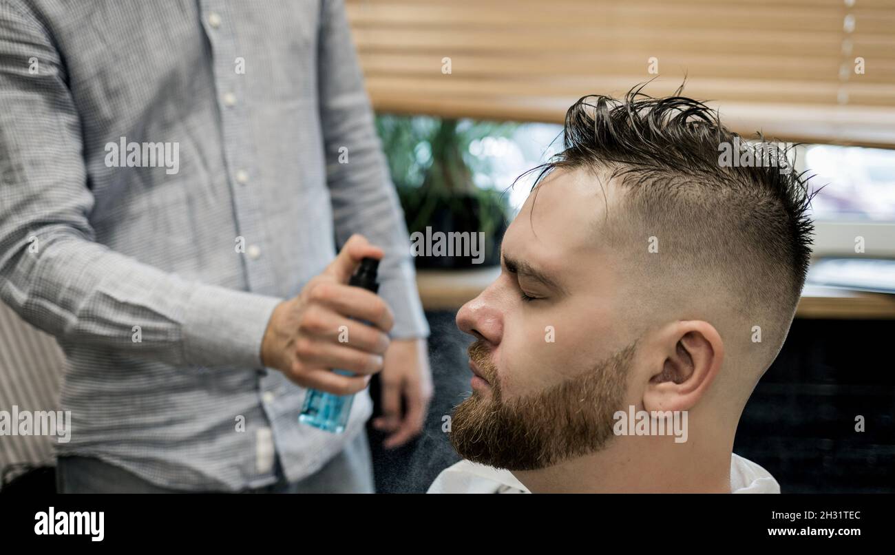 Client during beard and moustache grooming in barber shop Stock Photo Alamy