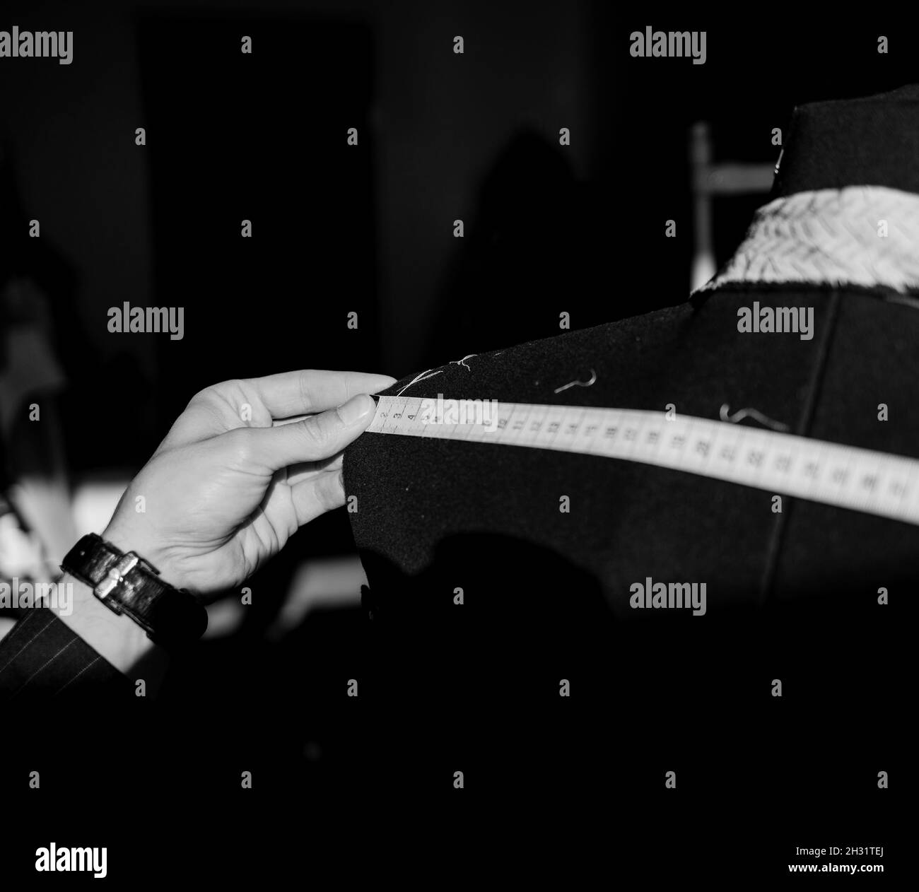 Tailor taking measure Black and White Stock Photos & Images Alamy