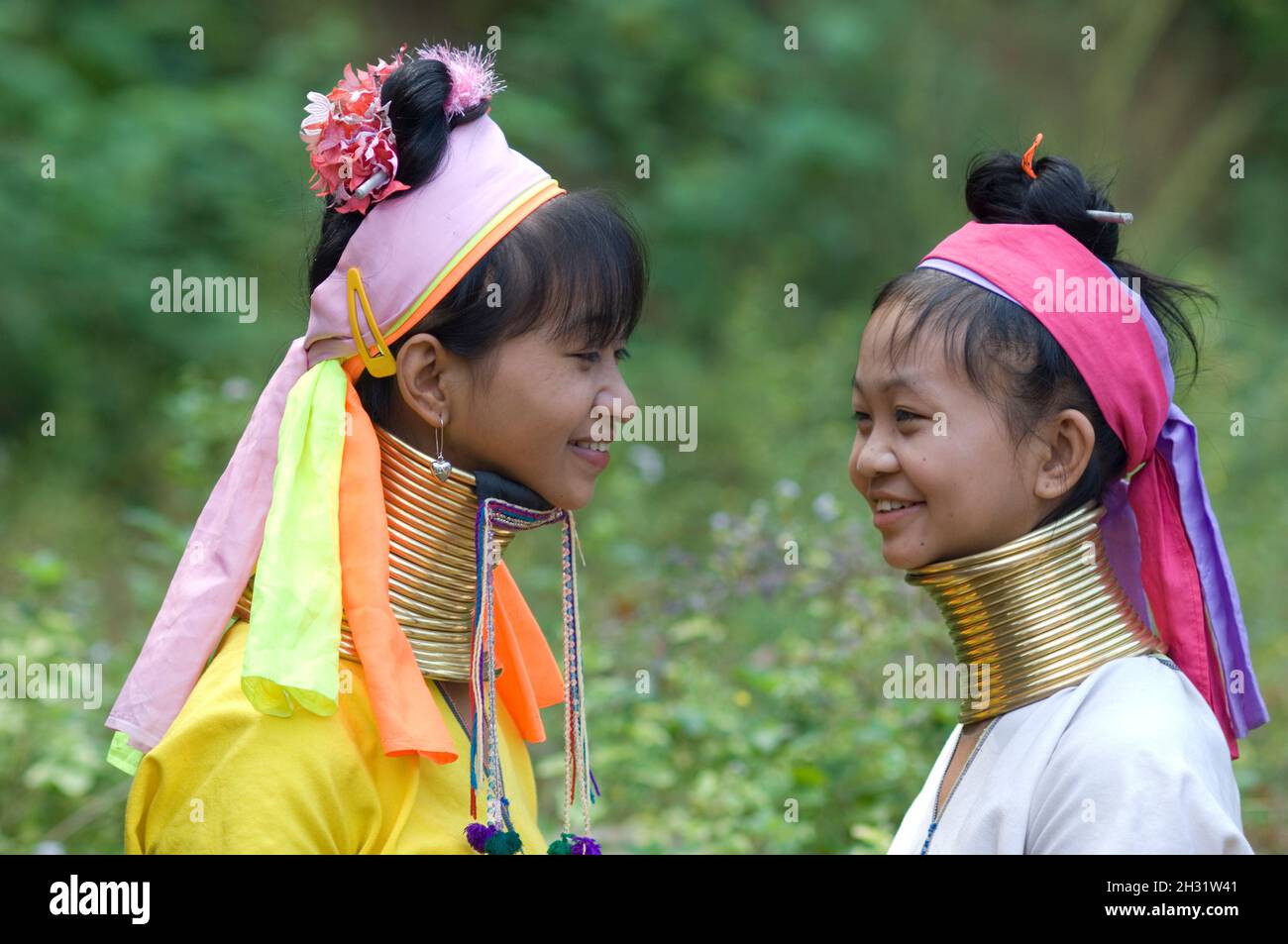 Two Long neck (Karan) hill tribe woman  smiling, Thailand Stock Photo