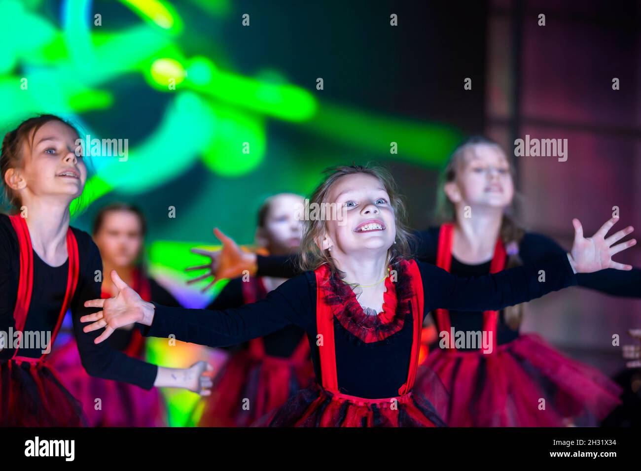 Little girls are performing a dance number. Dance for Helovinna in red ...