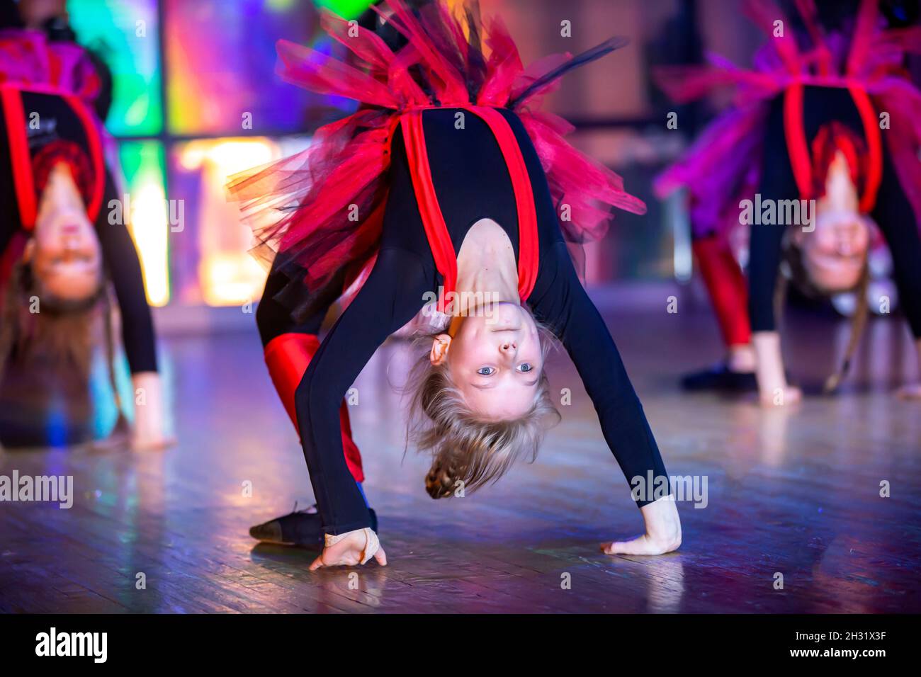 Little girls perform a dance number. Dance for helovinna in red
