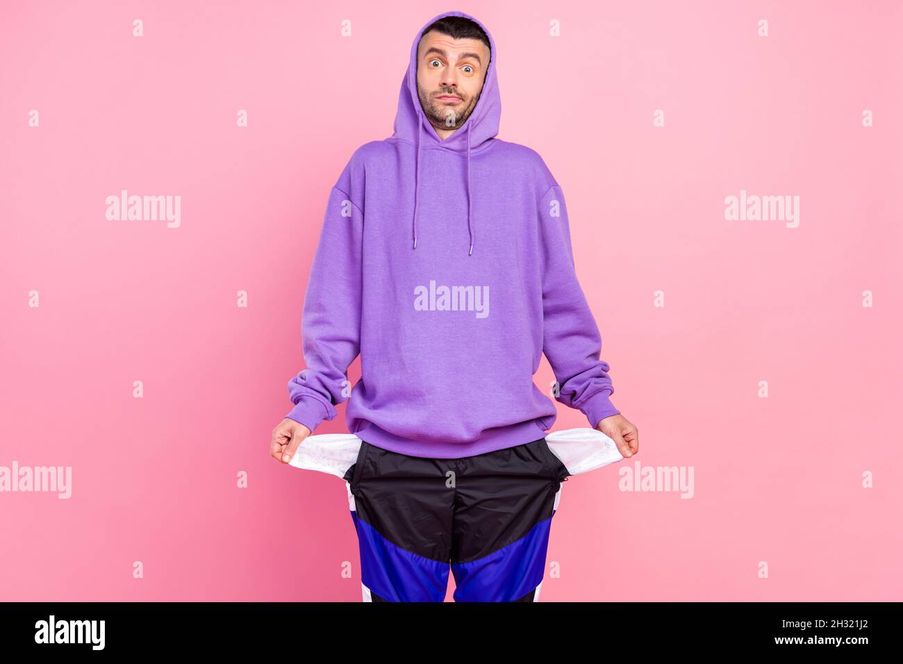 Photo of impressed millennial brunet guy wear violet hoodie isolated on pink color background Stock Photo Alamy