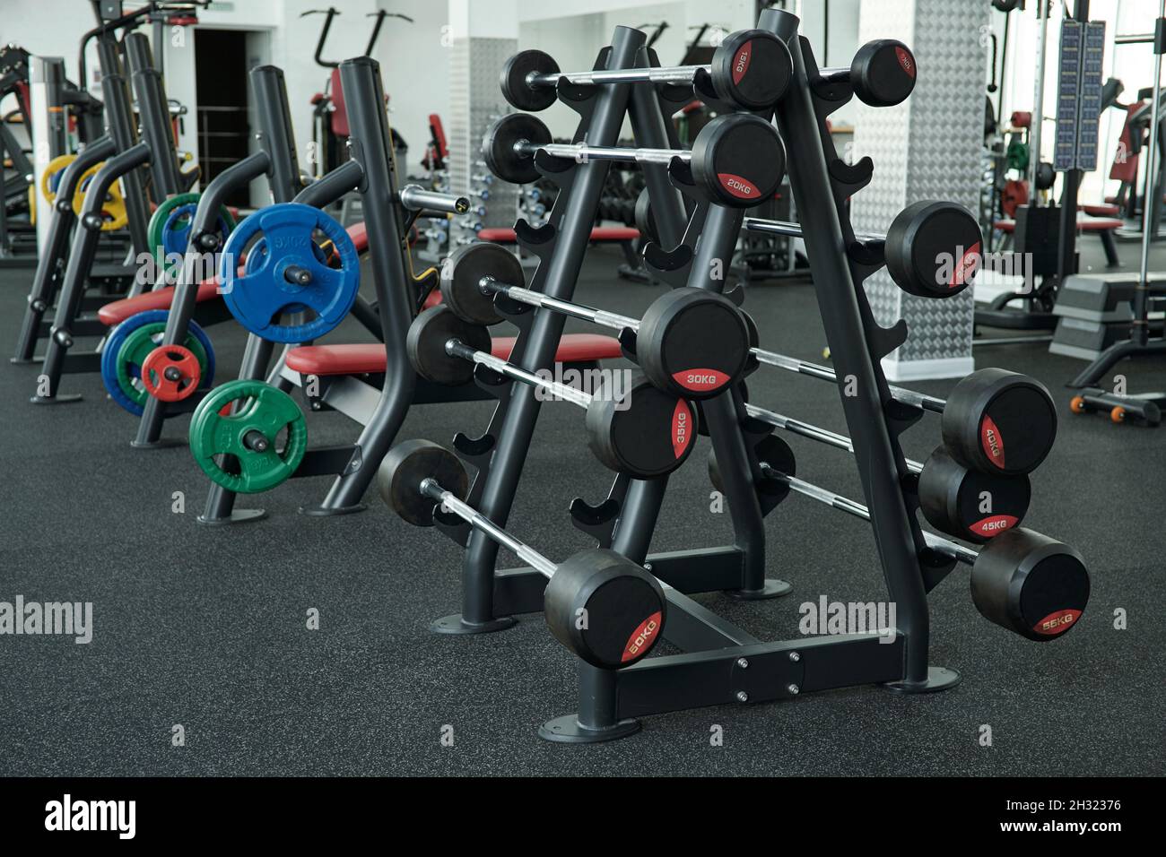 Sets of various weights for bodybuilding and weightlifting in side large contemporary gym of fitness center Stock Photo