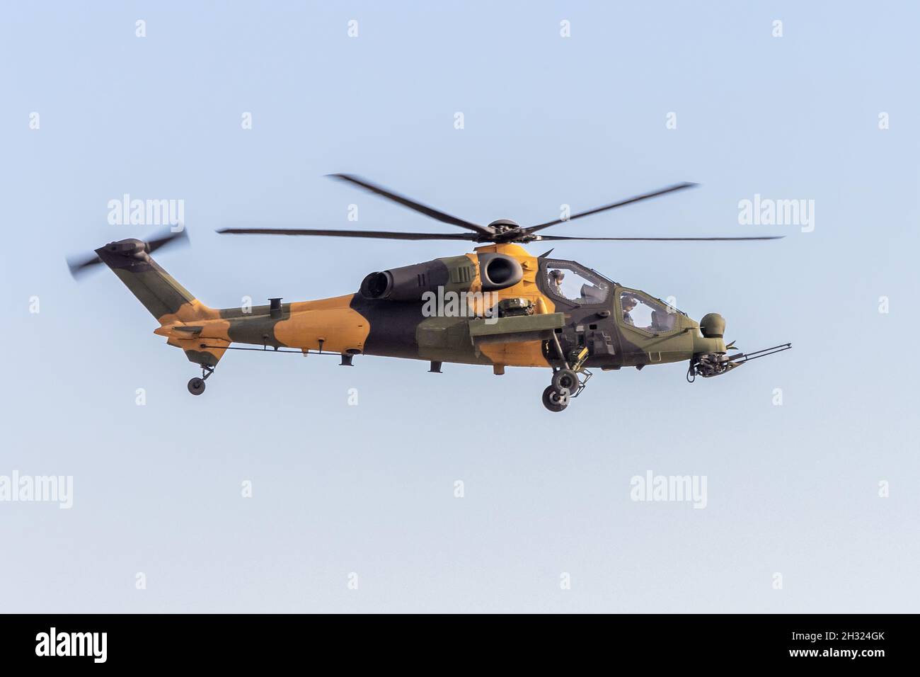 Military combat helicopter in flight Stock Photo