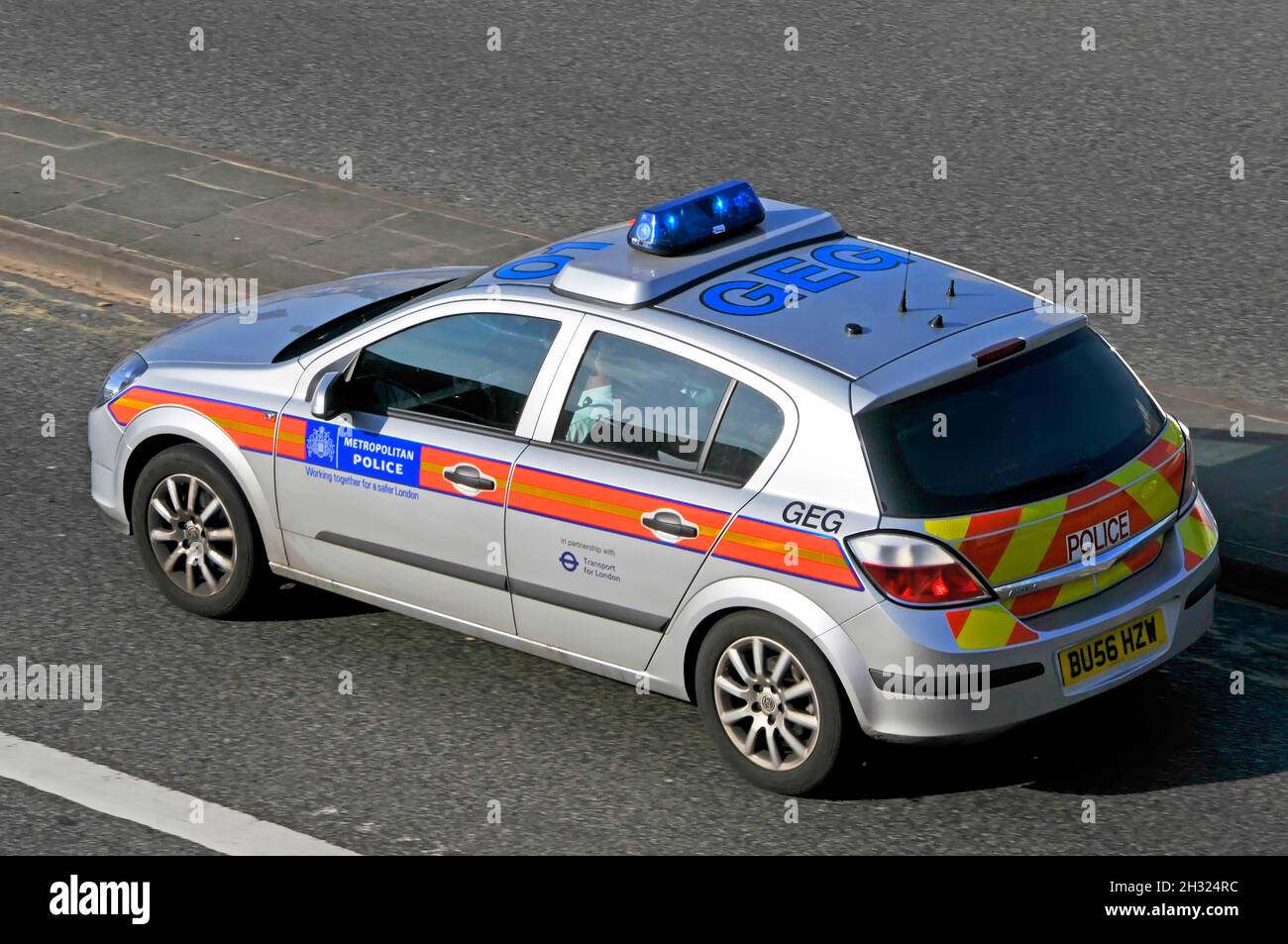Aerial street scene view side back & roof numbers on metropolitan police patrol car driving at speed on a blue light emergency call London England UK Stock Photo