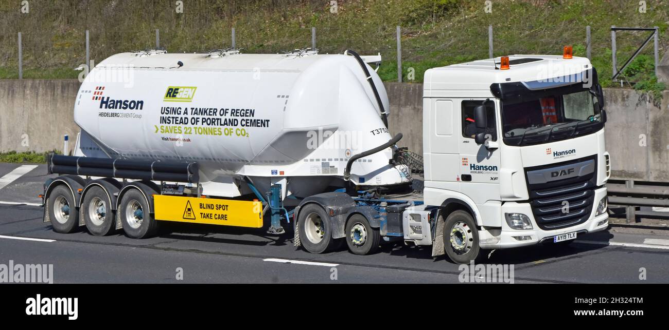 Advertising on Hanson Heidelberg cement business group bulk tanker trailer promoting Regen alternative to Portland Cement saves CO2  on UK motorway Stock Photo