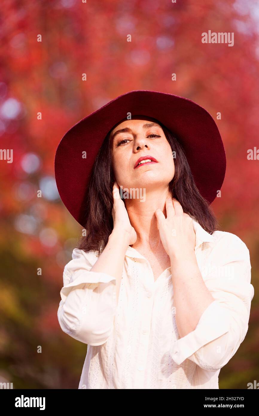 woman in red hat in an autumnal park V Stock Photo