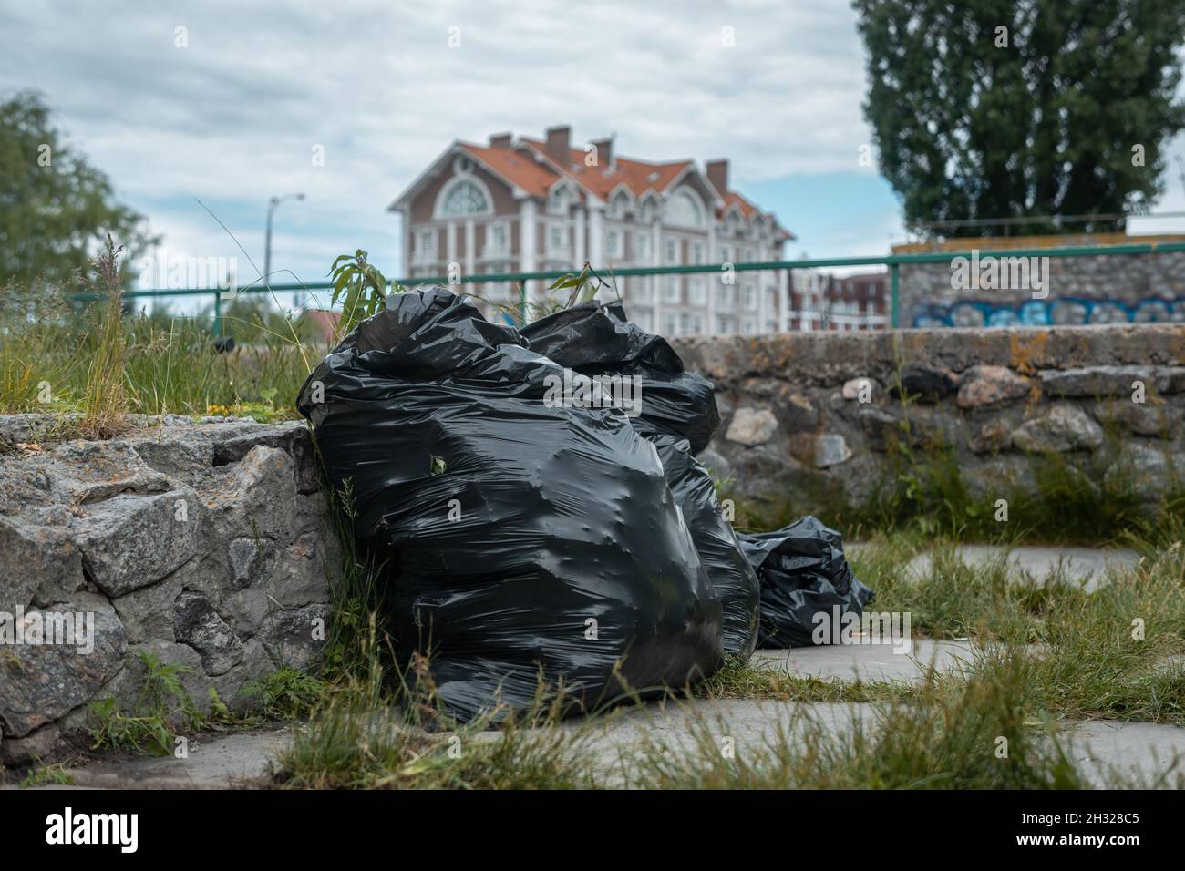 full black garbage bags with trash at city park outdoor after clean up Stock Photo Alamy