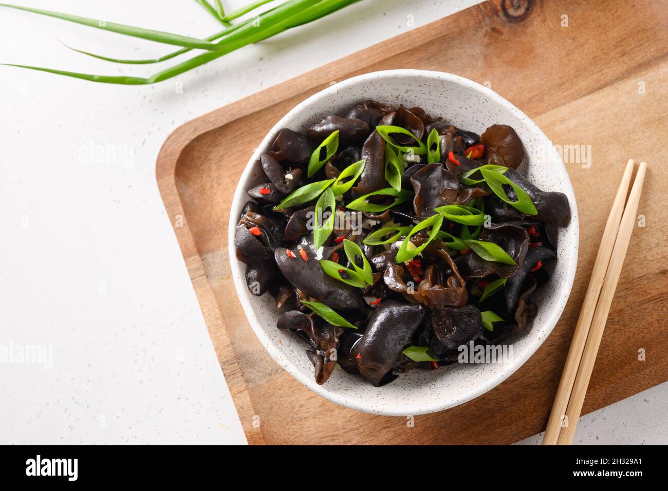 Salad of chinese pickled tree black muer mushrooms in bowl on white