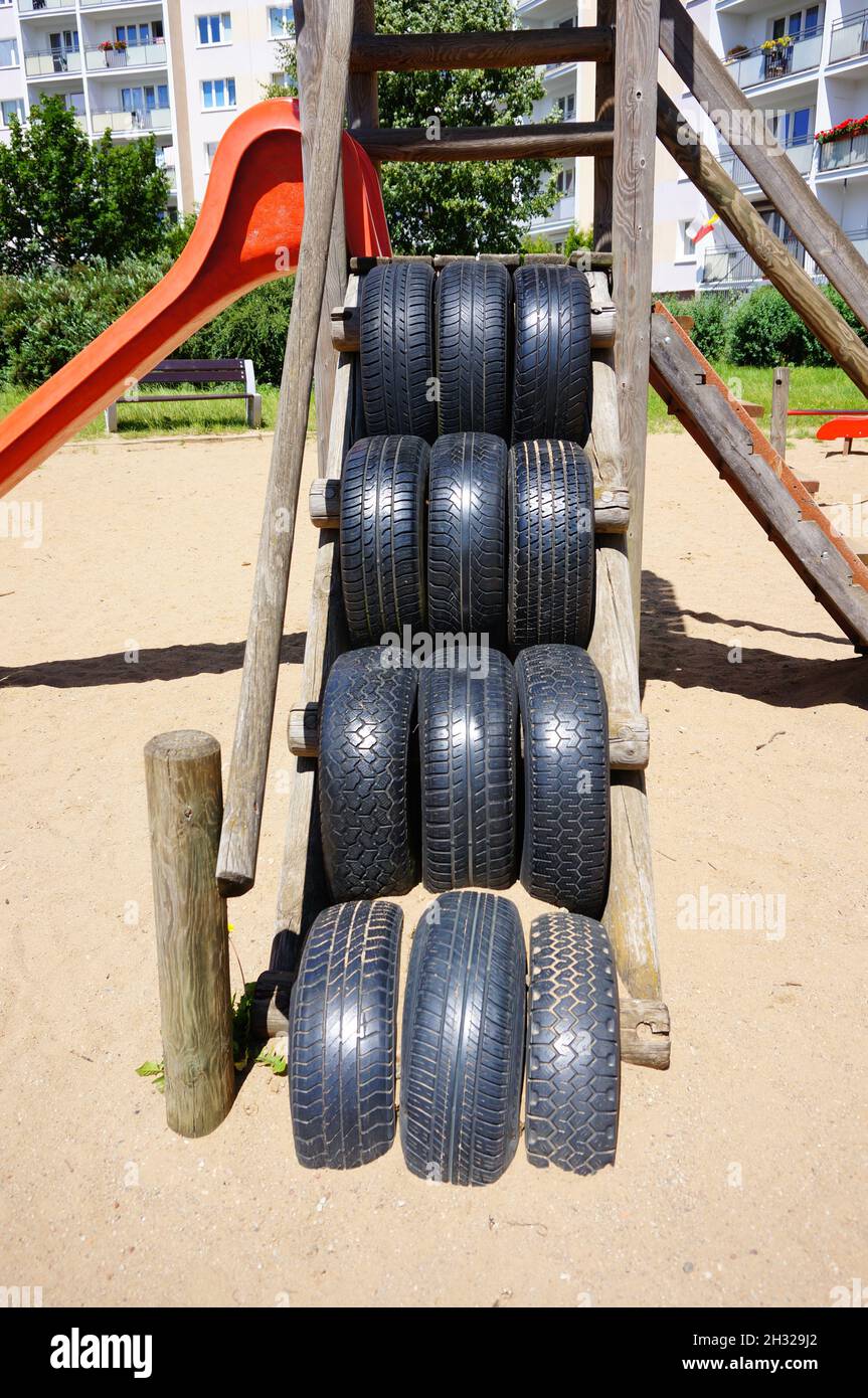 Tires of a playground equipment with slide Stock Photo Alamy