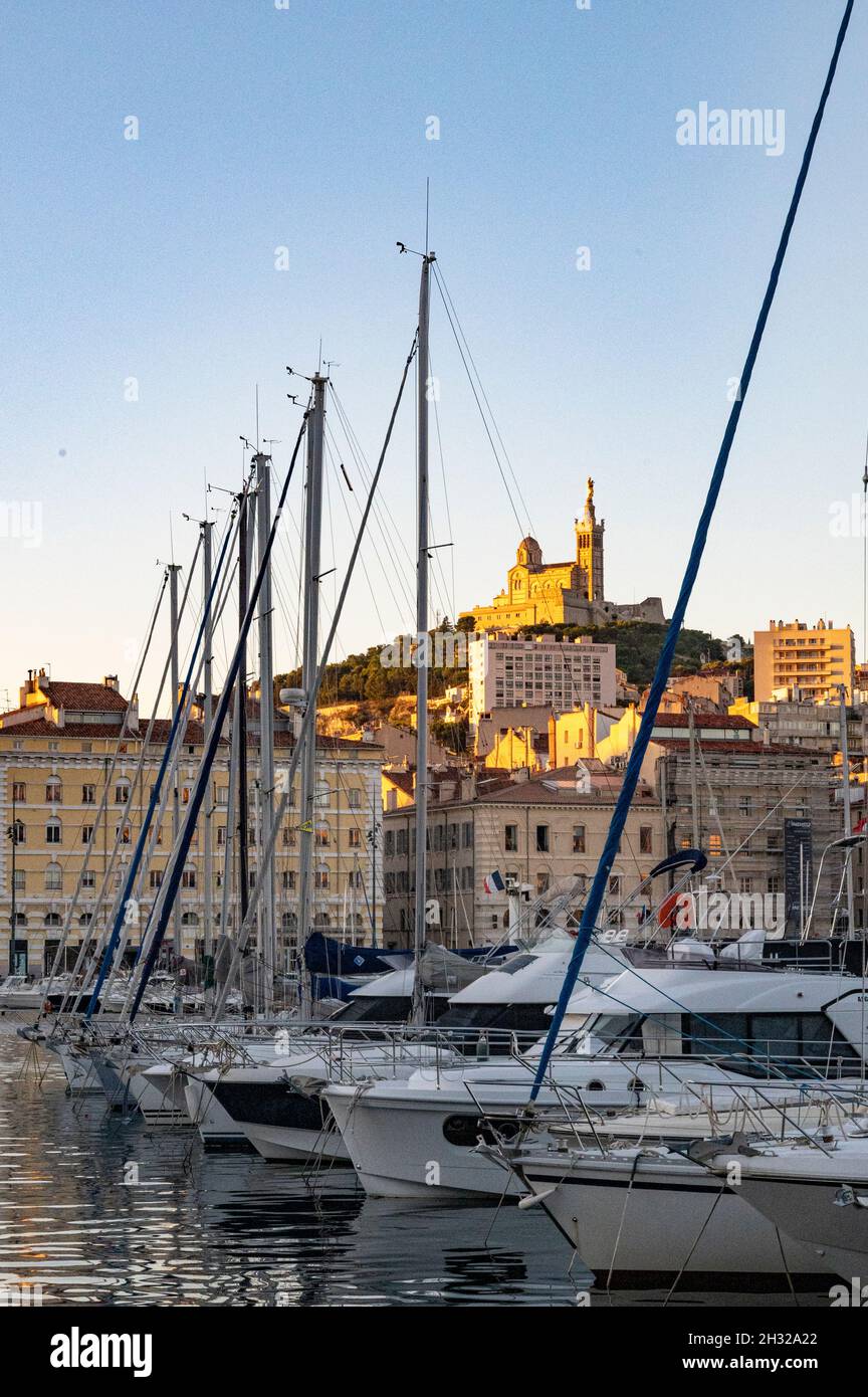 Morning in the vieux-port, the old harbour of Marseille, southern France.  Notre-Dame de la Garde watches over the ships Stock Photo - Alamy