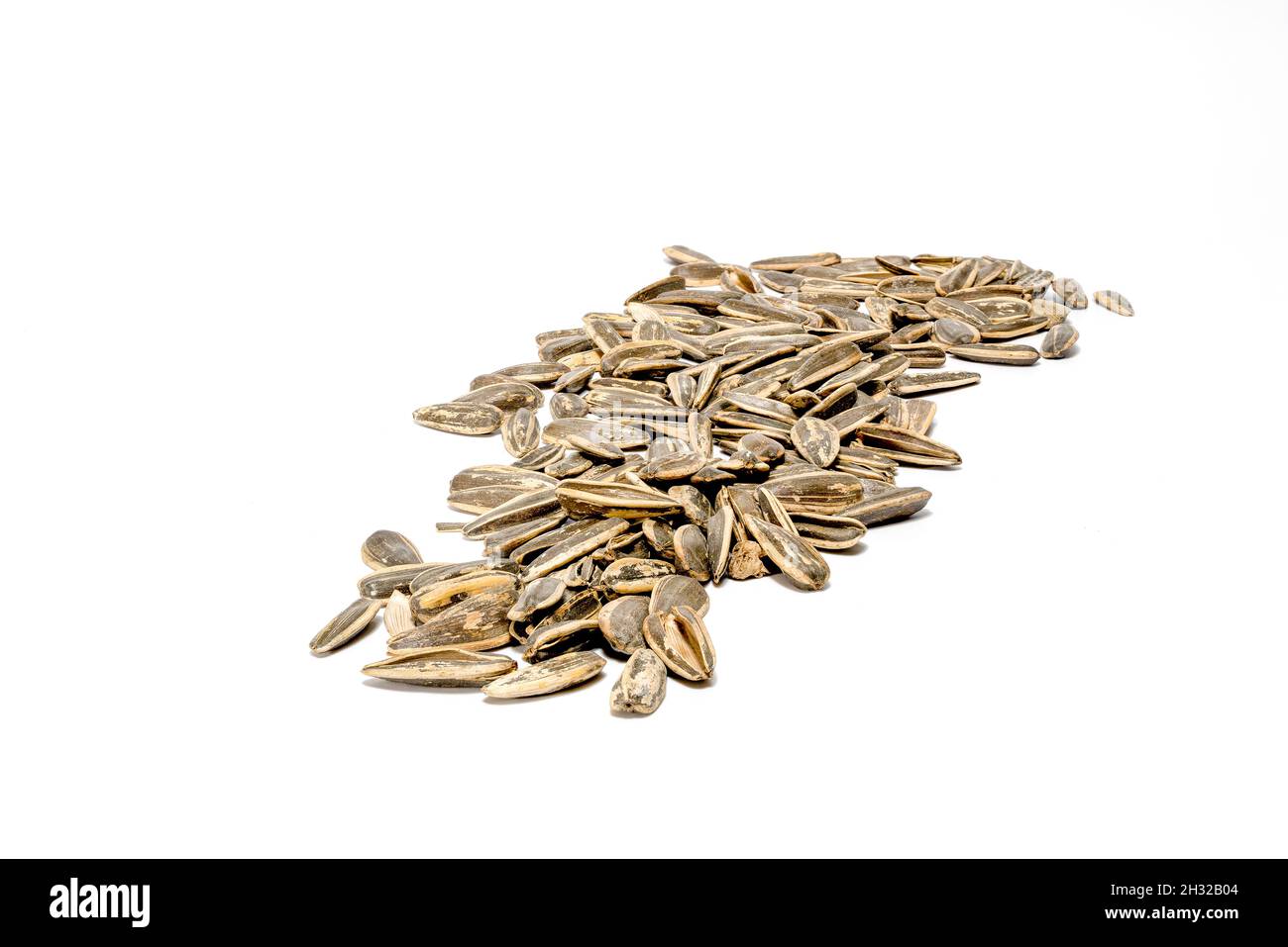 Heap of dry sunflower seeds. Isolated on a white background. Stock Photo