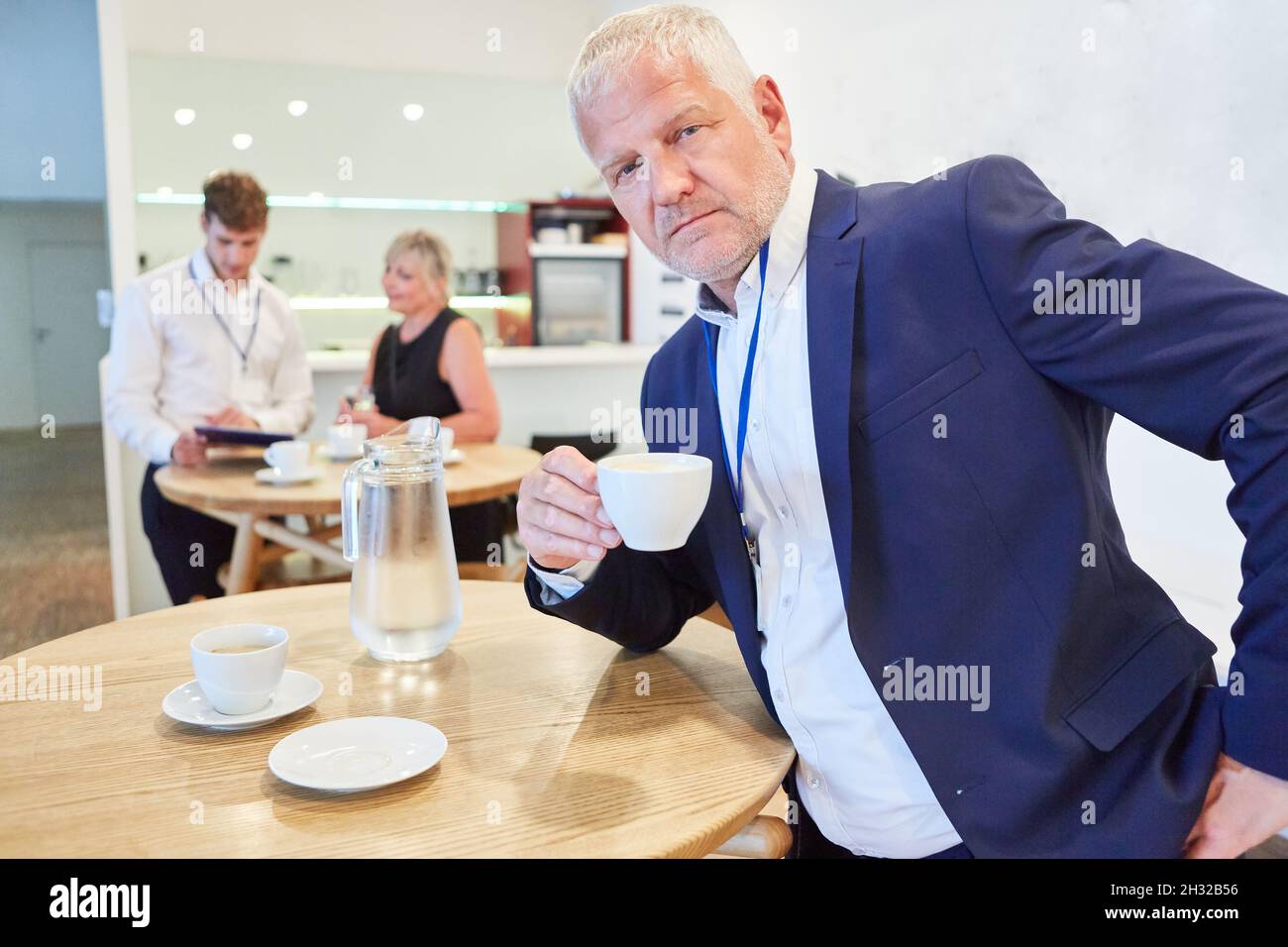 Senior business man drinking coffee during a break in the canteen in the office Stock Photo Alamy