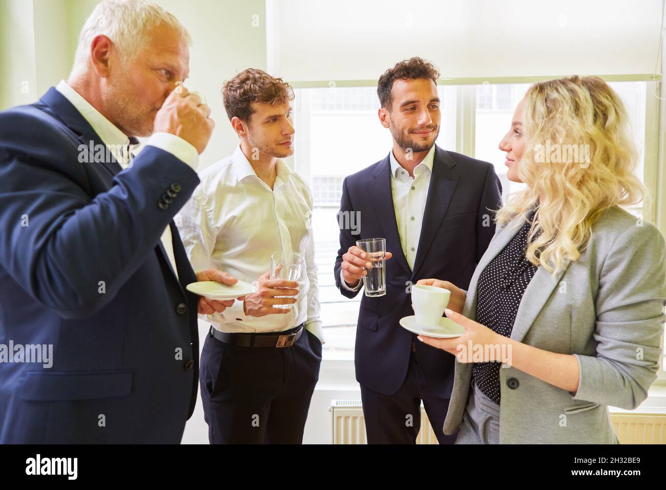 Group of business people on a coffee break having casual small talk Stock Photo