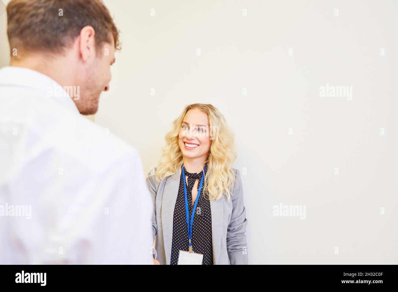 Young woman as a business woman and conference participant with ID card and name badge Stock Photo