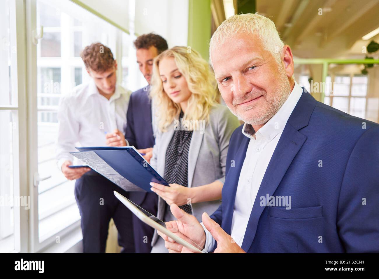 Managing director and business team with trainees in a training or advanced training course Stock Photo