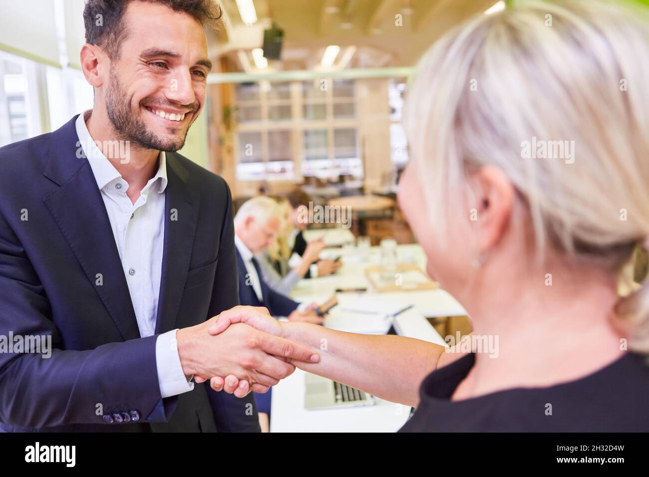 Business people shaking hands as a congratulation for a promotion or greeting Stock Photo