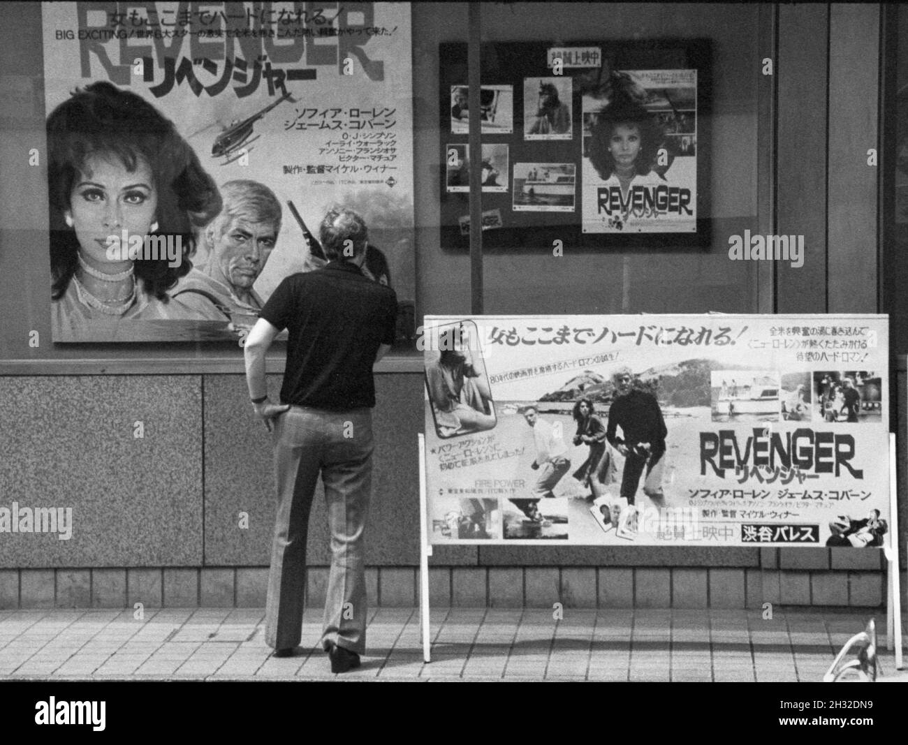 A man looks at posters for movies, Kyoto, Japan; 1979 Stock Photo