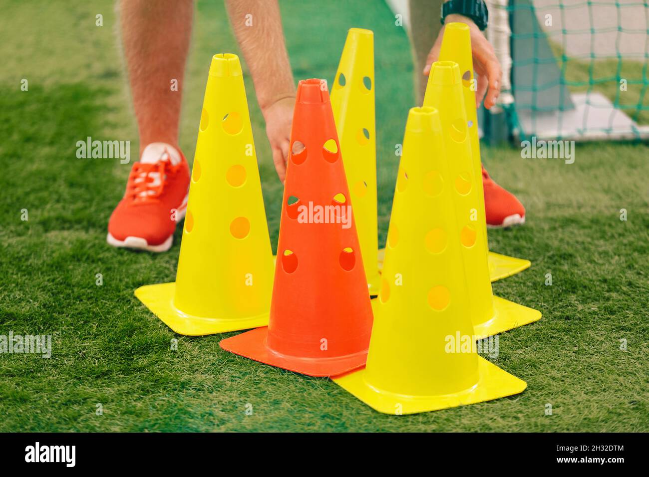 Football Training Cones. Coach Preparing Practice Soccer Field With Red