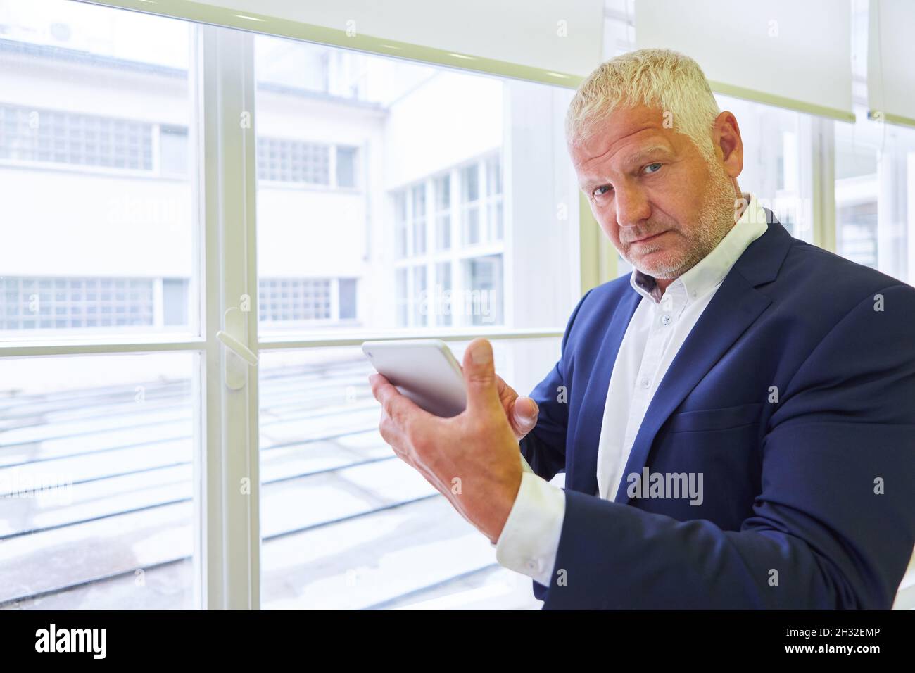 Senior business man as manager or consulting advisor using tablet computer Stock Photo