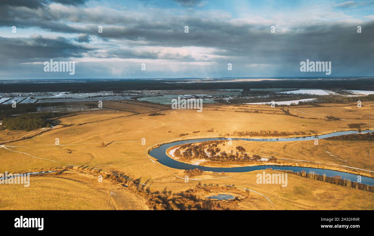 Aerial View Of Dry Meadow And Partly Frozen River Landscape In Sunny Autunn Day. Top View Of Beautiful European Nature From High Attitude In Autumn Stock Photo