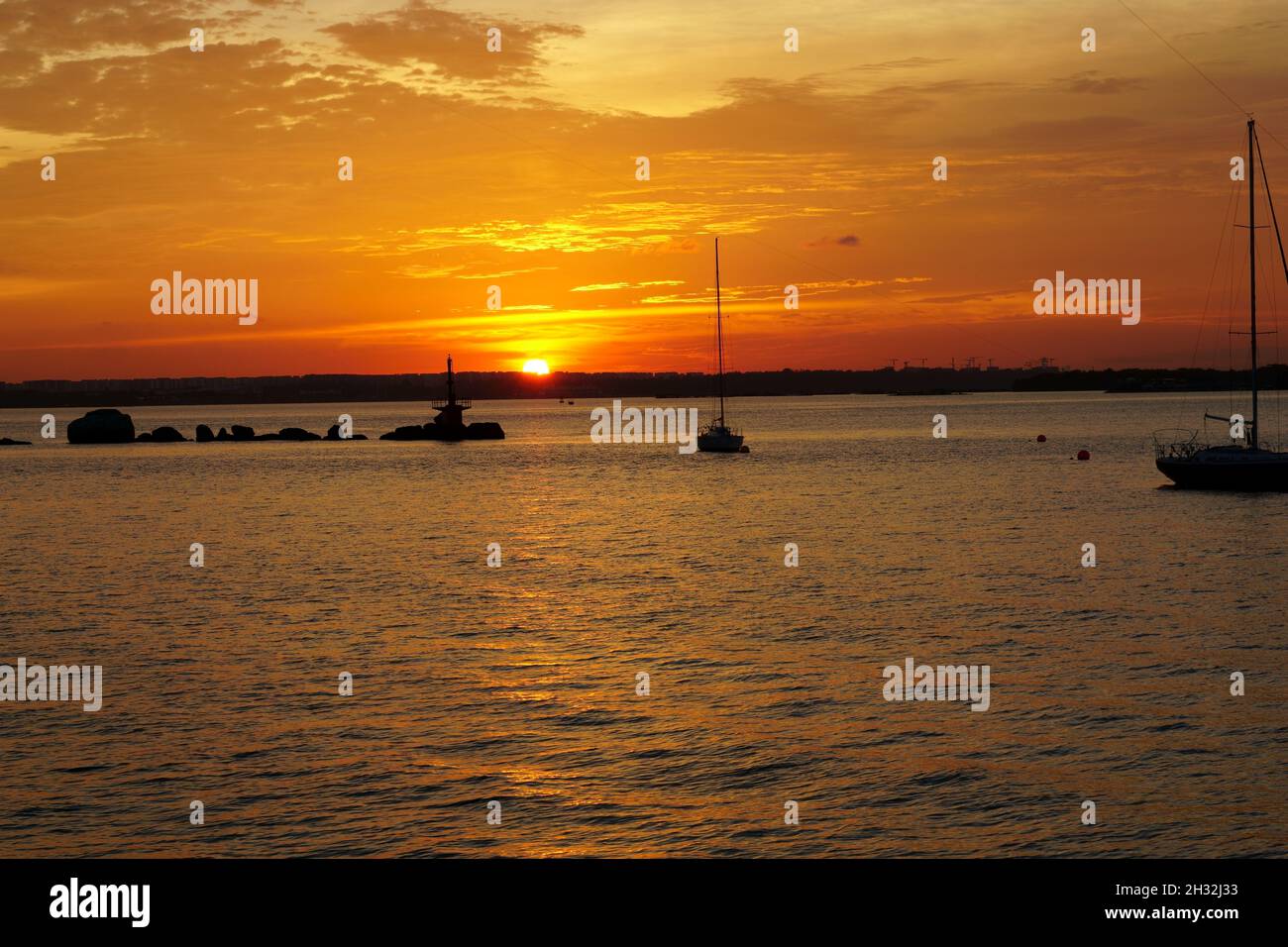 Beautiful natures sunset view on a non cloudy day at changi beach Stock Photo