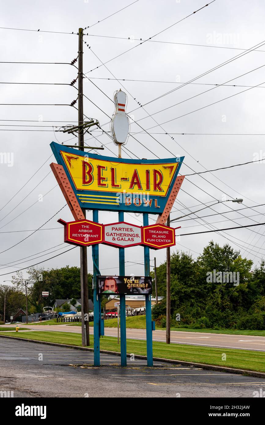 A tall retro sign for a bowling alley, BelAir Bowl topped with a giant