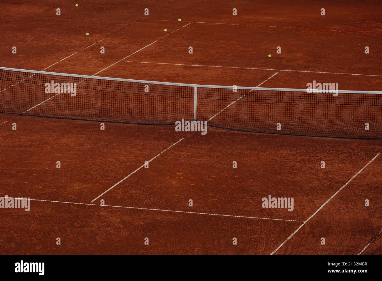 hard tennis court with balls on field Stock Photo