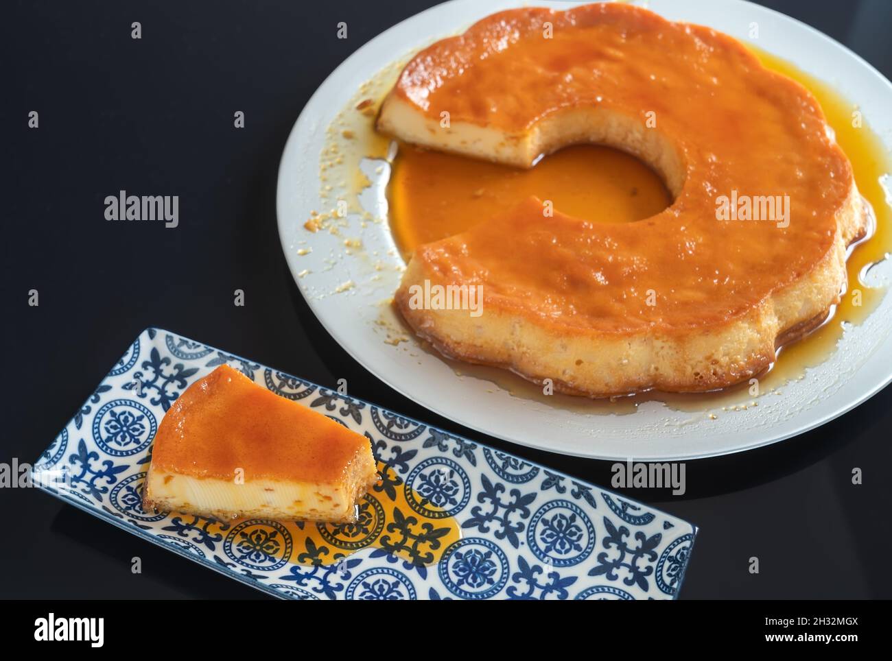 https://c8.alamy.com/comp/2H32MGX/pudding-delicious-brazilian-condensed-milk-dessert-cut-into-pieces-on-a-plate-2H32MGX.jpg
