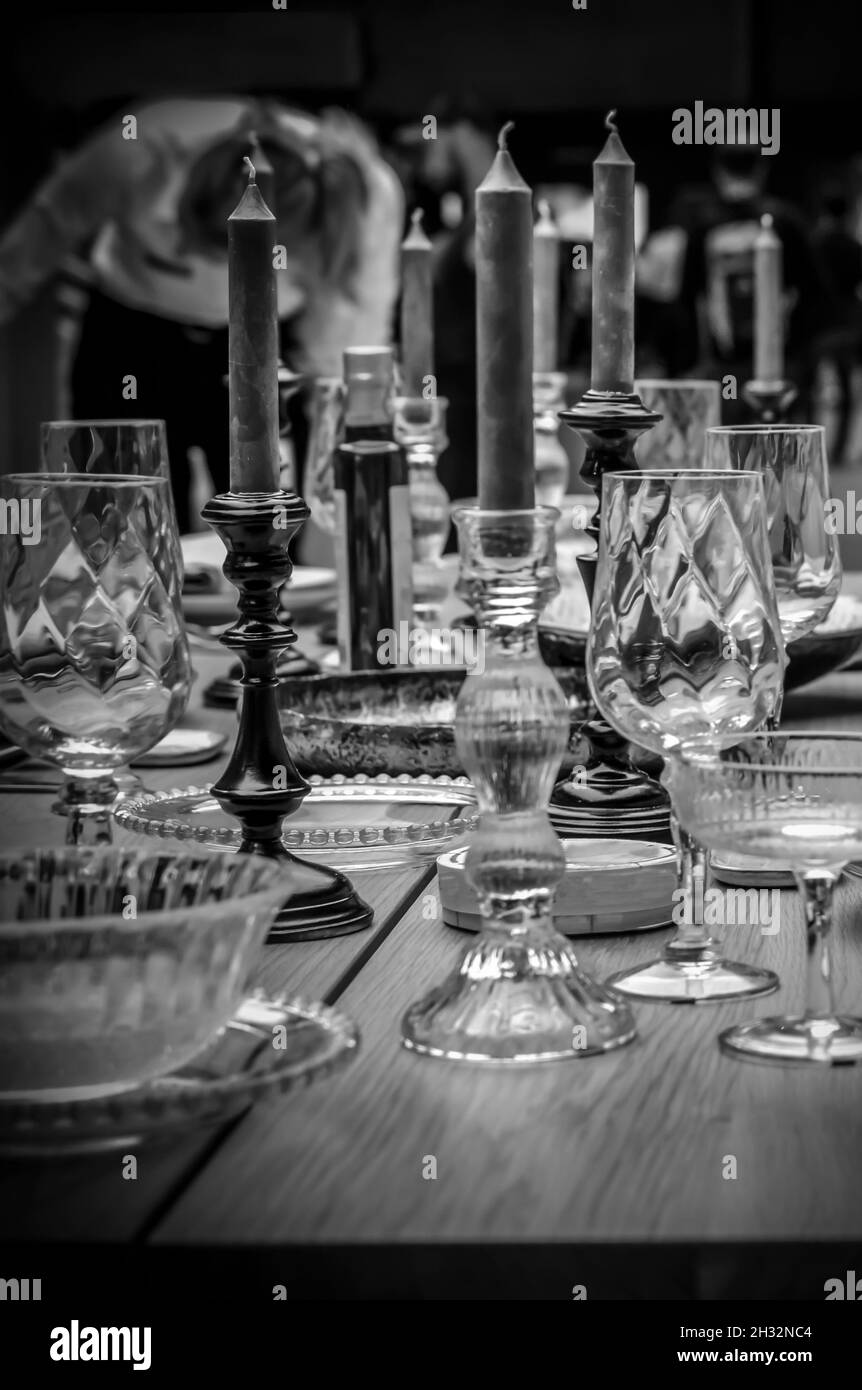 Glasses and plates on a fancy dining table in black and white Stock Photo