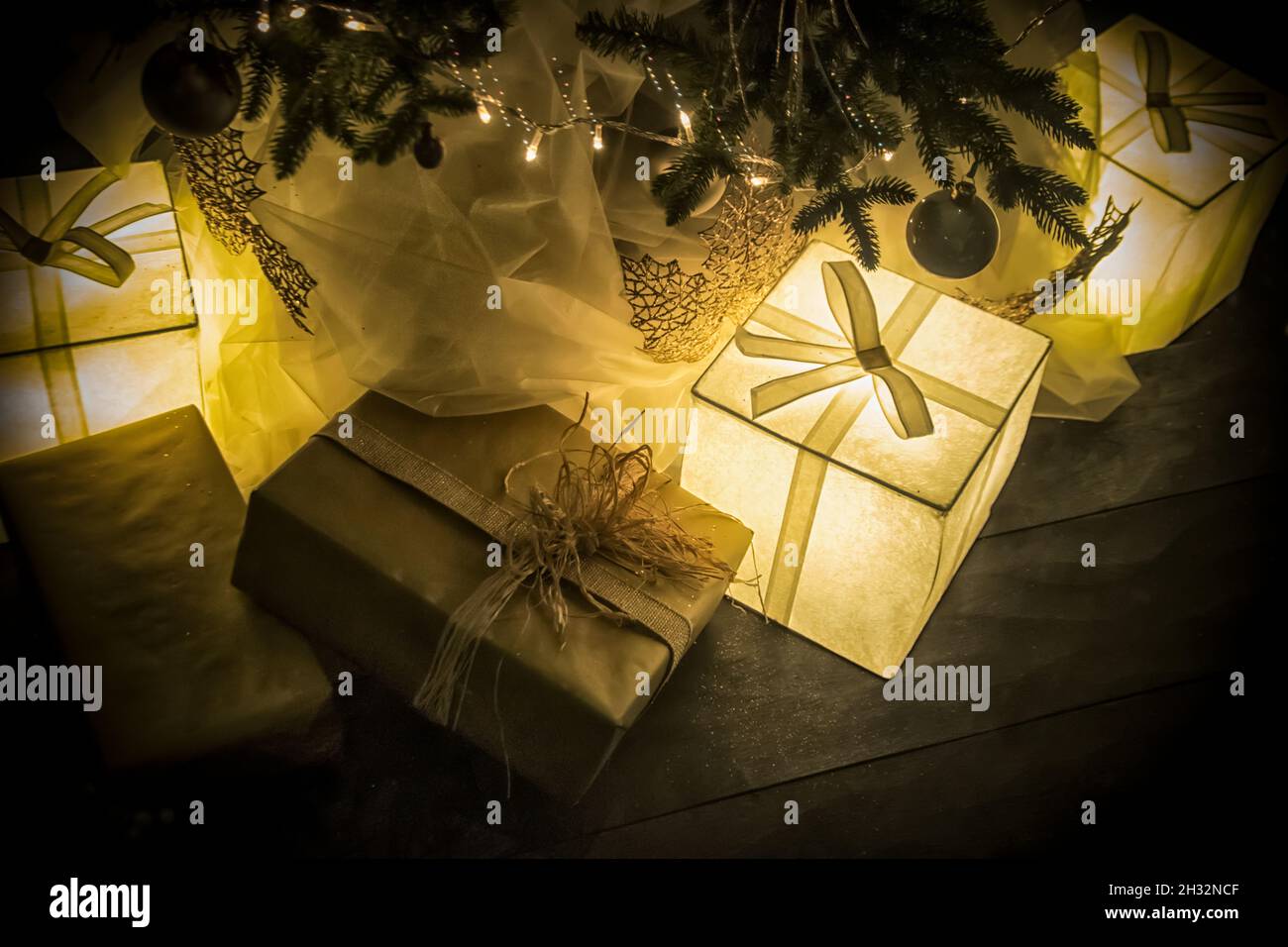 Illuminated presents under the Christmas tree Stock Photo