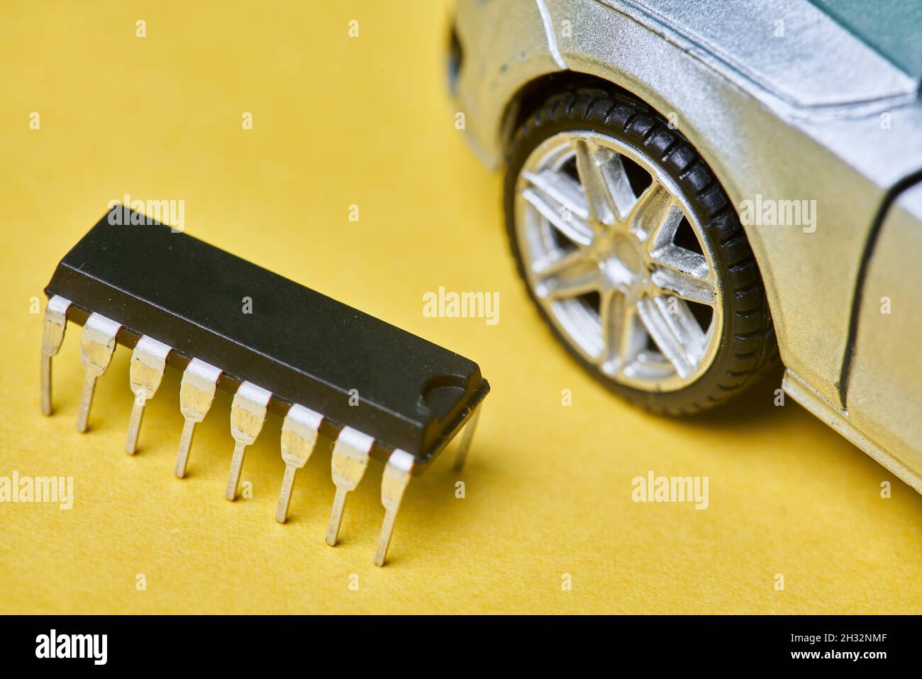 CPU chip and semiconductors with car toy. Global car chip shortage. Microchip shortage creates