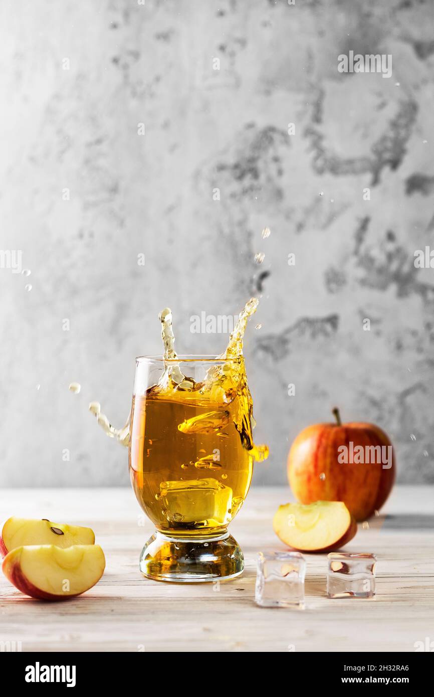 flying splashing apple juice on table Stock Photo