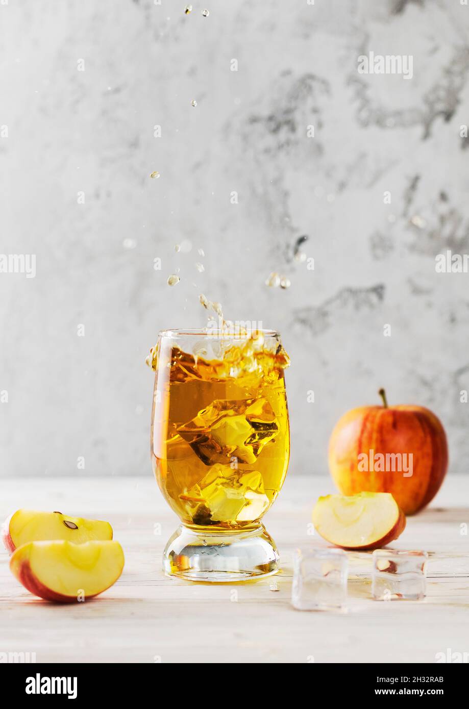 flying splashing apple juice on table Stock Photo