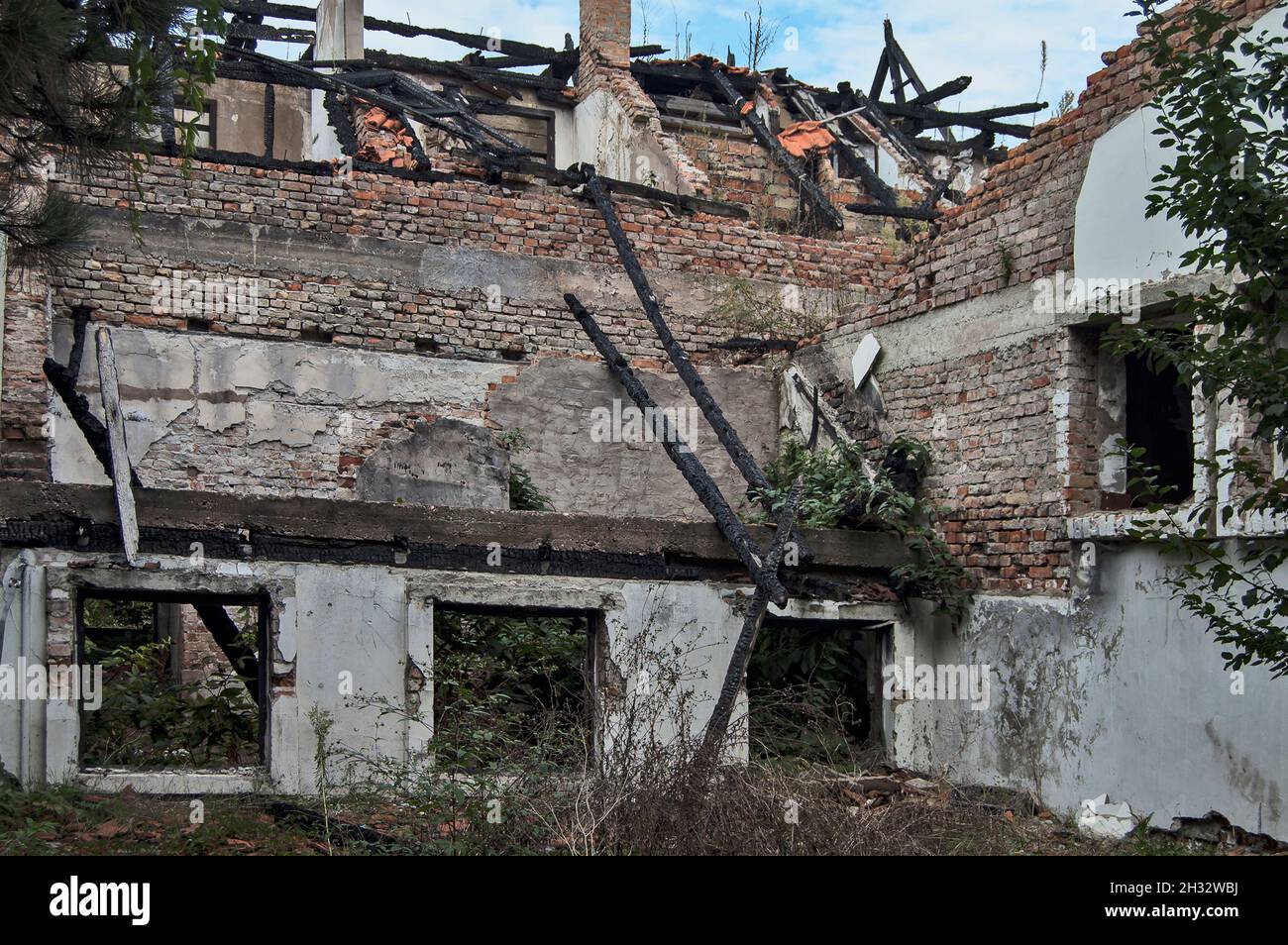 Ruins of an old house that has collapsed due to deterioration. Stock Photo