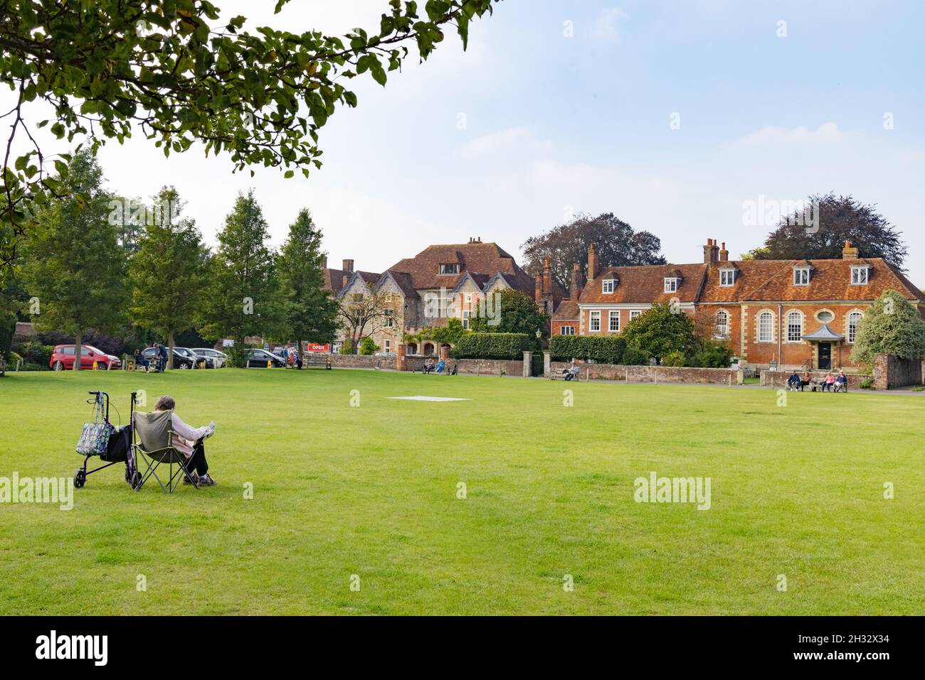 Cathedral Close, Salisbury Wiltshire UK; People sitting in the Close on a sunny day, Salisbury England. A quintessentially English scene. Stock Photo
