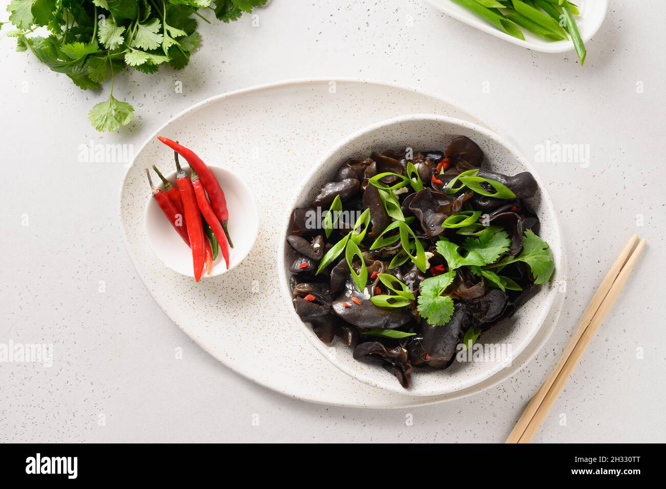Salad of pickled tree black muer mushrooms in bowl on white background
