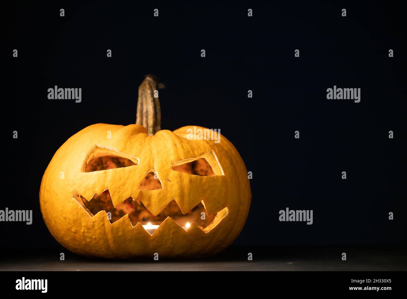 Jack O' Lanterns glowing in the night. Halloween background Stock Photo ...