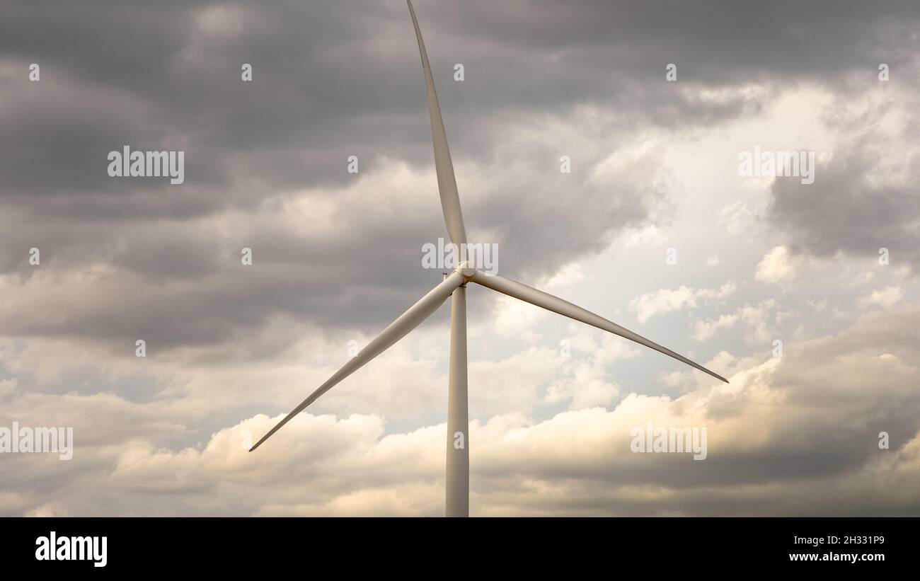 Wind turbine under a cloudy sky while driving through Texas Stock Photo ...